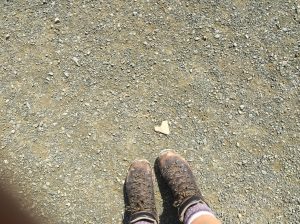 hiking boots next to a heart shaped rock
